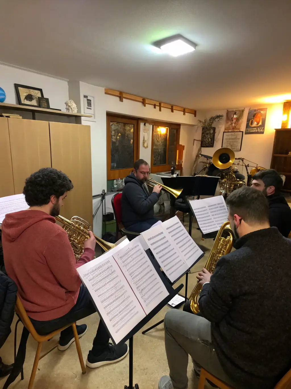 A professional shot of Glunk Association's rehearsal space, showcasing the band members collaborating and practicing their music, surrounded by instruments and equipment.